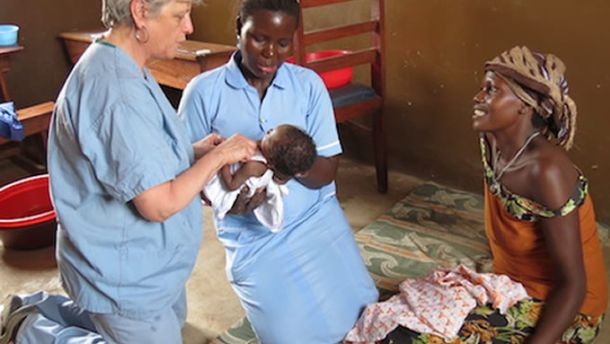 Midwives with baby and smiling mom