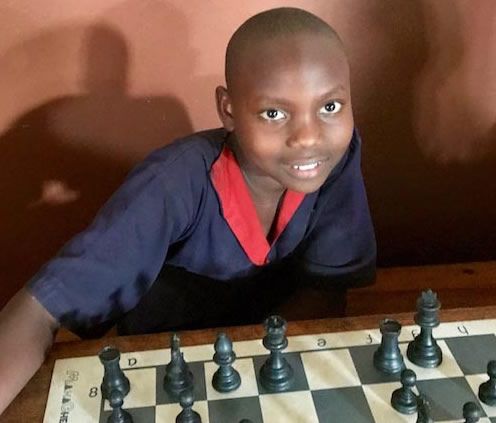 Boy at chess board