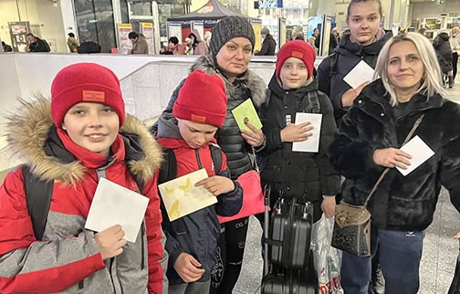 Group each holding a letter to mail